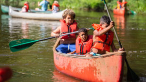 kids in a canoe at Camp West Mar