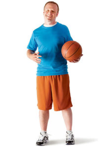 an adult holding a basketball