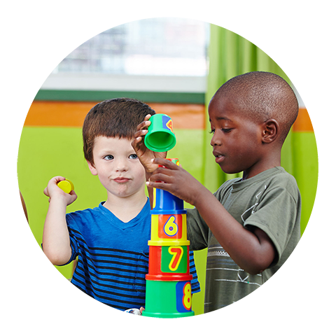 an african american and caucasian boy playing with toys