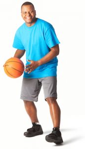 an african american male playing with a basketball