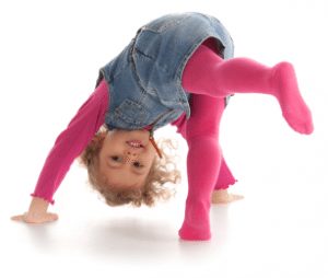 a little girl doing a handstand