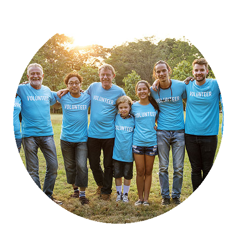 a group of volunteers posing for a picture outside.