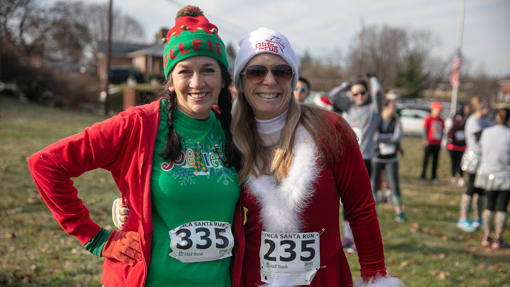 Photo of two women dressed up in red and green for Santa Run