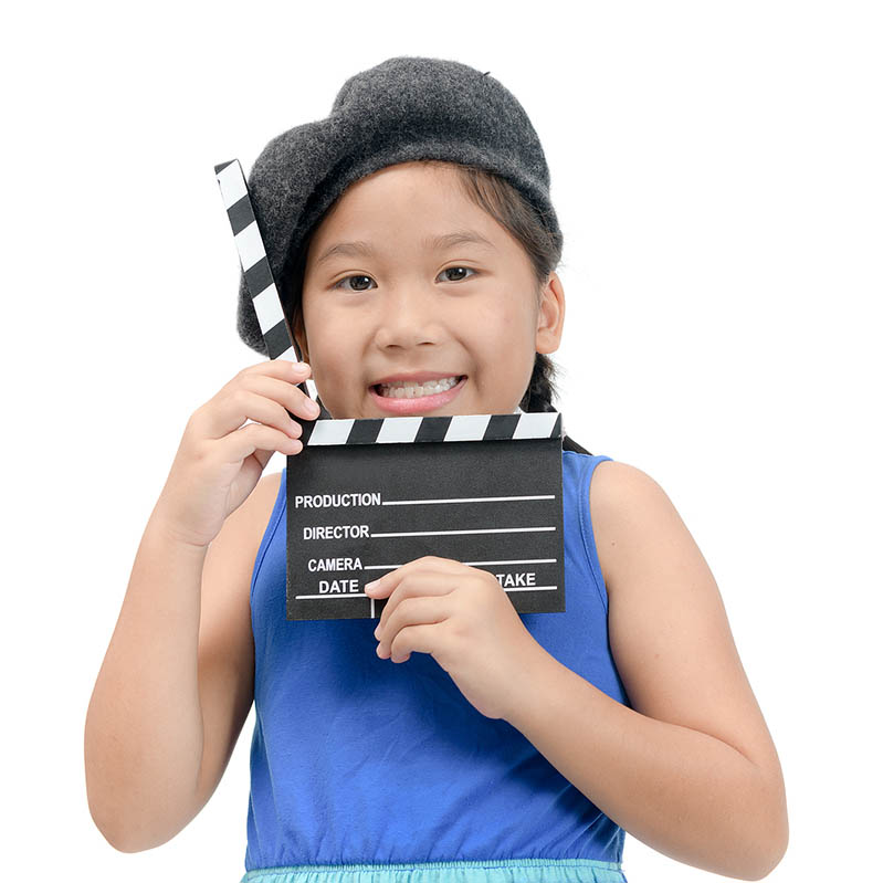 Little Director holding clapper board or slate film for making video cinema isolated on white background