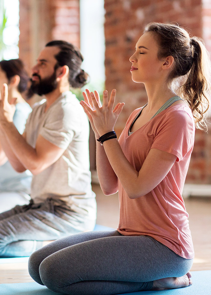 a man and woman doing yoga