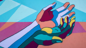 artwork of two hands out [...]
</p srcset=