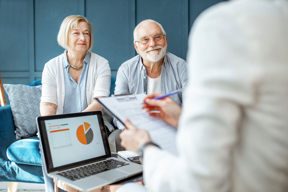 Older couple sitting with an estate planner