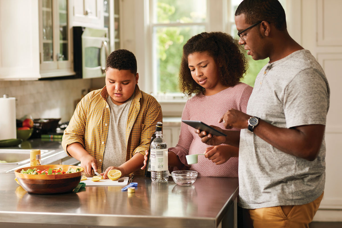 Family in kitchen preparing meal