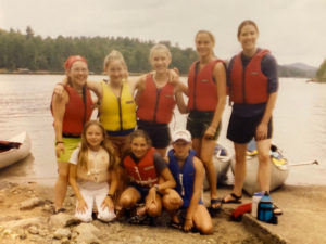group of campers and camp counselors with life vests on
