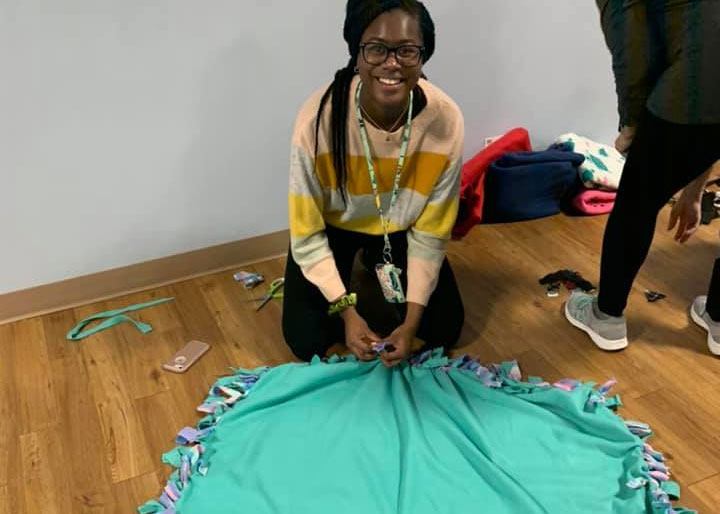 teen making fleece blanket