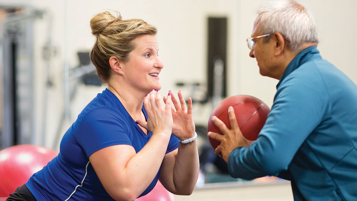 older male with personal trainer