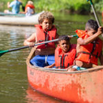 kids in a canoe at Camp West Mar