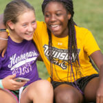 two girls at summer camp laughing