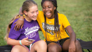two girls at summer camp laughing