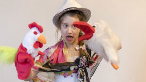 girl with puppets at puppetry camp