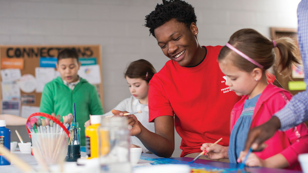 mentor overseeing painting class