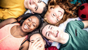 group of teens laughing