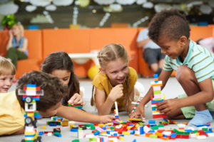 group of children playing legos 